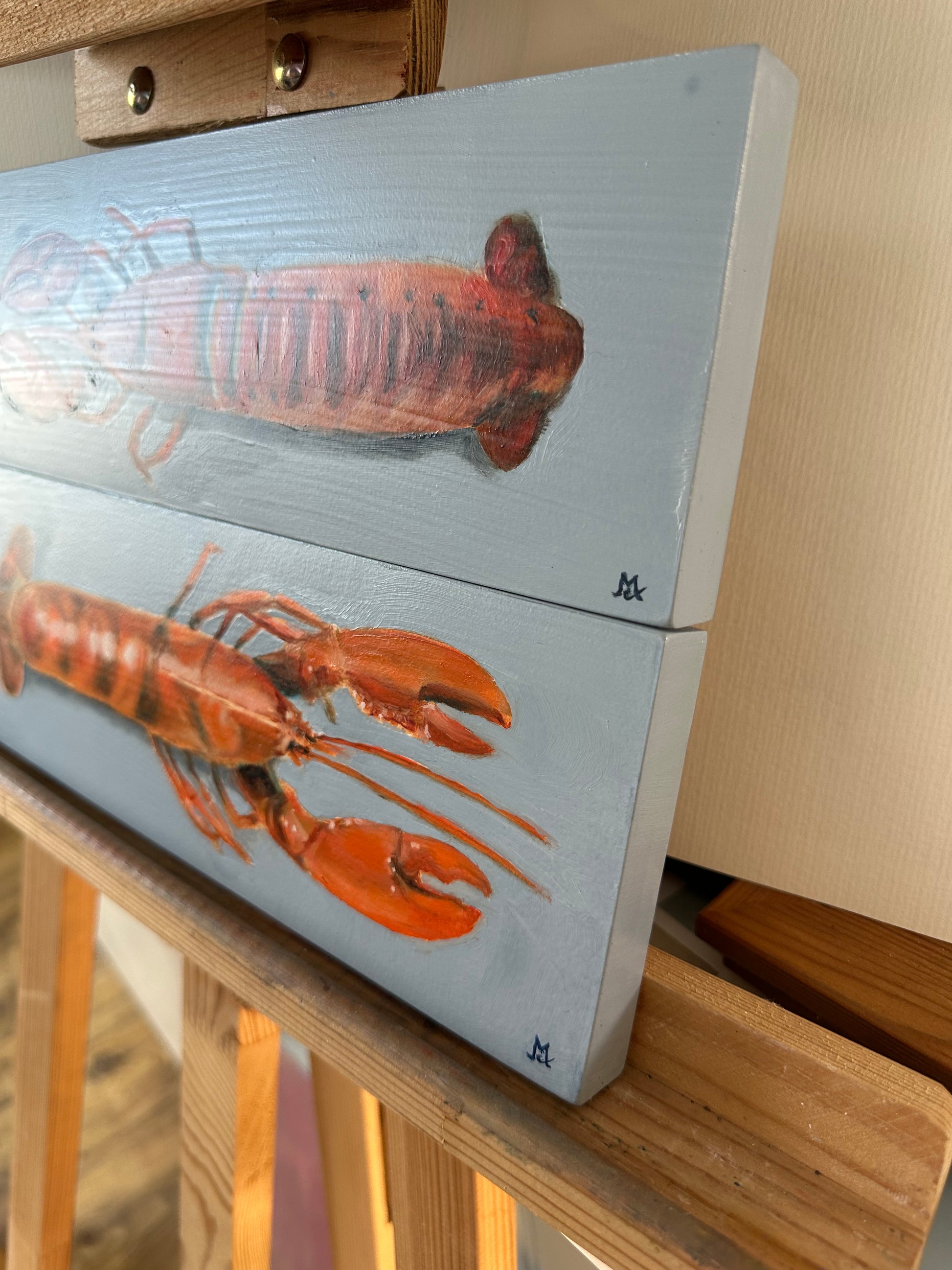 Original oil painting of a pair of lobsters on a blue background by Cotswold artist Susan McCraith