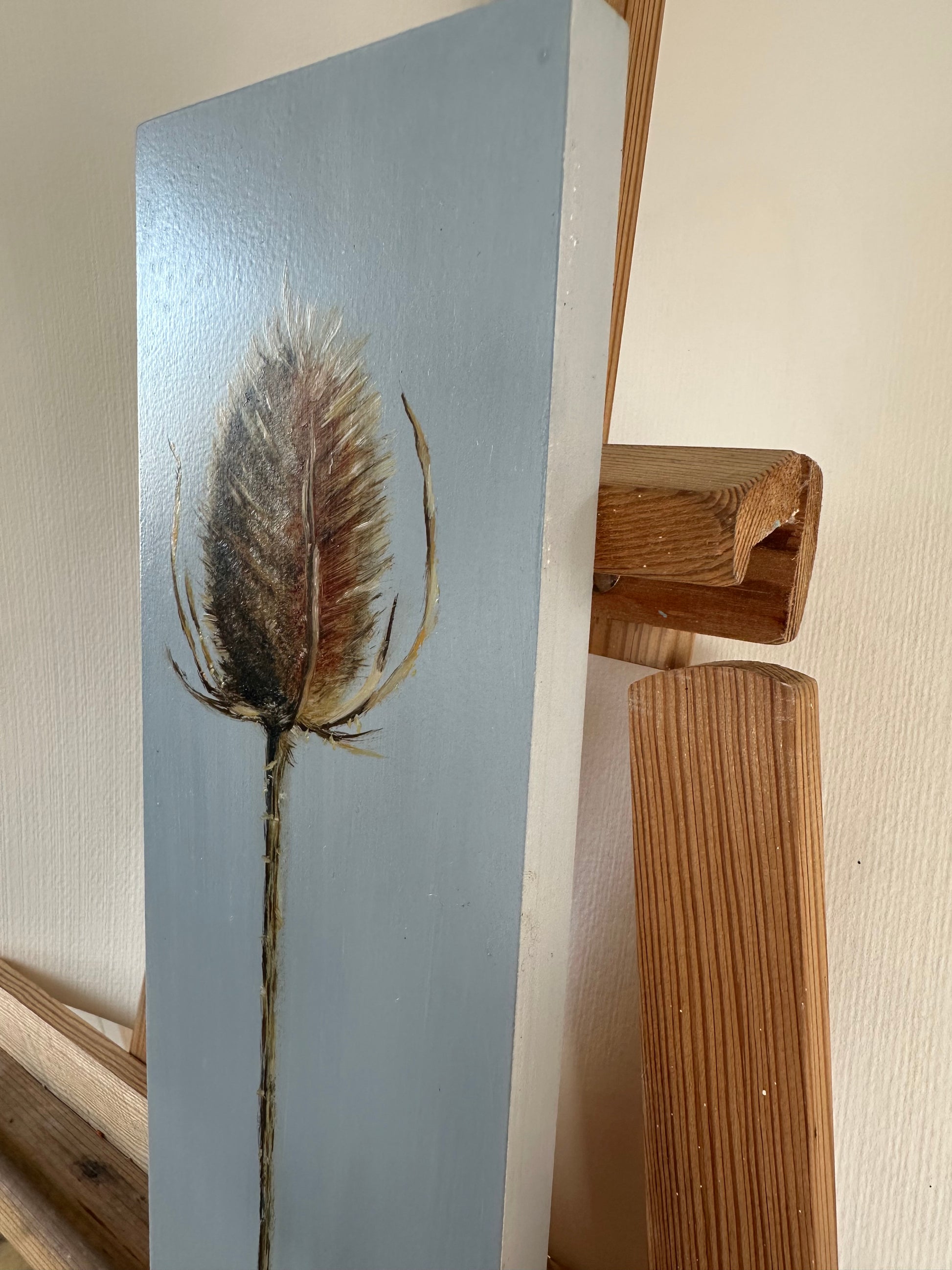 Original oil painting of a prickly teasel plant on a blue background by Cotswold artist Susan McCraith